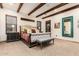 This main bedroom features wood ceiling beams, carpeted floors, and neutral colored walls at 23465 S 202Nd St, Queen Creek, AZ 85142