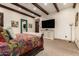 This main bedroom features carpeted floors, neutral colored walls, and a TV at 23465 S 202Nd St, Queen Creek, AZ 85142