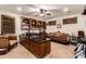 Office with coffered ceiling, hardwood desk, and comfortable sitting area at 23465 S 202Nd St, Queen Creek, AZ 85142