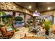 Luxurious outdoor living area with stone arches, comfortable seating, a fire pit, and views of the pool at 23465 S 202Nd St, Queen Creek, AZ 85142