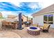 Outdoor patio features a built-in bar, grill, and a cozy tiled fire pit with chairs, perfect for entertaining at 23465 S 202Nd St, Queen Creek, AZ 85142