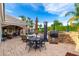 Lovely backyard patio with comfortable seating, a built-in grill, and a dining table, perfect for outdoor entertaining at 23465 S 202Nd St, Queen Creek, AZ 85142