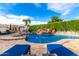 Backyard lagoon pool with waterfall and view of the home at 23465 S 202Nd St, Queen Creek, AZ 85142