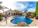 Lagoon style pool in backyard with spa, waterfall, seating and landscaping at 23465 S 202Nd St, Queen Creek, AZ 85142