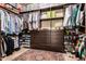 This walk in closet features custom built in cabinetry and shelving for maximum storage at 23465 S 202Nd St, Queen Creek, AZ 85142
