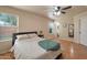 Cozy bedroom featuring plush bedding, ample natural light, and wood flooring at 2366 E Spruce Dr, Chandler, AZ 85286