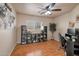 Comfortable office space with wood floor, dark shelving unit, and a bright window at 2366 E Spruce Dr, Chandler, AZ 85286