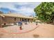 Expansive backyard featuring a pool, mature landscaping, and an outdoor seating area with a fire pit at 2405 E Lynwood Cir, Mesa, AZ 85213