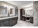 Bathroom featuring dual vanities, a makeup area, and access to the bedroom at 2405 E Lynwood Cir, Mesa, AZ 85213