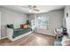 Well-lit bedroom featuring a daybed, writing desk, and large window at 2405 E Lynwood Cir, Mesa, AZ 85213