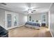A cozy bedroom featuring French doors and a ceiling fan at 2405 E Lynwood Cir, Mesa, AZ 85213
