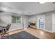 Bright bedroom with wood floors, a comfortable bed, natural light, and access to the backyard through a glass door at 2405 E Lynwood Cir, Mesa, AZ 85213