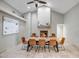 Bright dining room with a long table and a fireplace in the background, perfect for Gathering meals and gatherings at 2405 E Lynwood Cir, Mesa, AZ 85213