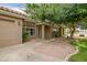 Inviting front entrance with neutral stucco, tile roof, desert landscaping, and an arched window at 2405 E Lynwood Cir, Mesa, AZ 85213