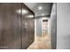 Hallway with built-in storage leading to a bathroom at 2405 E Lynwood Cir, Mesa, AZ 85213