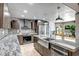 Open kitchen features an island with pendant lighting, custom cabinets, and granite countertops at 2405 E Lynwood Cir, Mesa, AZ 85213