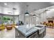 Open kitchen with island, granite countertops, stainless steel sink, and natural light at 2405 E Lynwood Cir, Mesa, AZ 85213