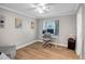 Office space with hardwood floors, a large window, and modern furniture at 2405 E Lynwood Cir, Mesa, AZ 85213