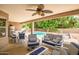 Outdoor living space with an inviting covered patio featuring seating, a dining area, and views of the pool and garden at 2405 E Lynwood Cir, Mesa, AZ 85213