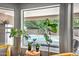 View of pool area through windows with lush landscaping at 2405 E Lynwood Cir, Mesa, AZ 85213