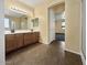 Bathroom features dual sinks, wood cabinets, tile floors, and a glass shower at 2521 N Franz Ln, Casa Grande, AZ 85122