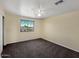 Comfortable bedroom with neutral walls, plush carpet, and a bright window at 2521 N Franz Ln, Casa Grande, AZ 85122