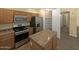 Well-equipped kitchen with stainless steel appliances, gas range, and a pantry at 2521 N Franz Ln, Casa Grande, AZ 85122