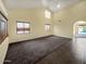 Bright living room with plush carpeting, a high ceiling, and natural light at 2521 N Franz Ln, Casa Grande, AZ 85122