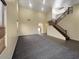 Spacious living area featuring plush carpeting, staircase, and an open layout at 2521 N Franz Ln, Casa Grande, AZ 85122