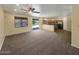 Open-concept living space with carpet, tile, kitchen, and sliding glass doors at 2521 N Franz Ln, Casa Grande, AZ 85122