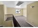 Open upstairs loft with a window offering natural light and plush carpet at 2521 N Franz Ln, Casa Grande, AZ 85122