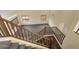 Open staircase featuring carpeted stairs and wood railing with natural light at 2521 N Franz Ln, Casa Grande, AZ 85122