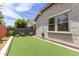 Backyard with artificial grass, privacy wall, and convenient water hose, low maintenance at 2605 S Quaintance St, Gilbert, AZ 85295