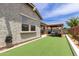 Backyard featuring artificial grass, convenient water hose, and a charming gazebo, perfect for outdoor entertaining at 2605 S Quaintance St, Gilbert, AZ 85295