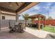 Inviting backyard featuring a covered patio, outdoor dining area, gazebo, and lush turf for relaxation and entertainment at 2605 S Quaintance St, Gilbert, AZ 85295