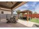 Outdoor patio with gazebo, a dining area, and artificial grass for easy maintenance at 2605 S Quaintance St, Gilbert, AZ 85295
