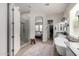 Spacious bathroom with a walk-in shower, soaking tub, dual vanities, and access to the main bedroom at 2605 S Quaintance St, Gilbert, AZ 85295
