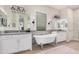 Elegant bathroom featuring a freestanding tub, dual vanities, and stylish fixtures, with a serene and luxurious design at 2605 S Quaintance St, Gilbert, AZ 85295