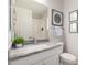 Bright bathroom with granite countertops, modern fixtures, framed artwork, and soft lighting at 2605 S Quaintance St, Gilbert, AZ 85295