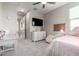 Inviting bedroom with a desk, TV and soft pink accents, perfect for relaxation and study at 2605 S Quaintance St, Gilbert, AZ 85295