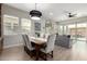 Bright dining area with a dining table next to open living room and sliding glass doors to the backyard at 2605 S Quaintance St, Gilbert, AZ 85295