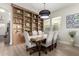 Inviting dining room featuring a large built-in bookcase, stylish furnishings, and ample natural light at 2605 S Quaintance St, Gilbert, AZ 85295