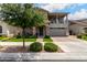 Inviting home with stone accents, porch seating, and lush landscaping at 2605 S Quaintance St, Gilbert, AZ 85295