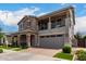 Beautiful two-story home with a stone facade, balcony, and a well-manicured front yard at 2605 S Quaintance St, Gilbert, AZ 85295