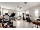 Spacious home gym equipped with a variety of machines, a ceiling fan, and natural lighting at 2605 S Quaintance St, Gilbert, AZ 85295