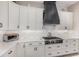 Well-equipped kitchen features stainless steel appliances, white cabinets, tiled backsplash, and modern fixtures at 2605 S Quaintance St, Gilbert, AZ 85295
