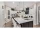 Modern kitchen with stainless steel appliances, a large island with seating, white cabinets, and a pantry at 2605 S Quaintance St, Gilbert, AZ 85295
