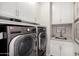 Convenient laundry room with modern appliances, ample cabinetry, and a practical sink area at 2605 S Quaintance St, Gilbert, AZ 85295