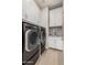 Well-equipped laundry room with a large washer and dryer, ample storage cabinets, and a sink for added convenience at 2605 S Quaintance St, Gilbert, AZ 85295