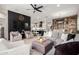 Spacious living room with a large sectional sofa, modern decor, and an adjacent eat-in kitchen at 2605 S Quaintance St, Gilbert, AZ 85295